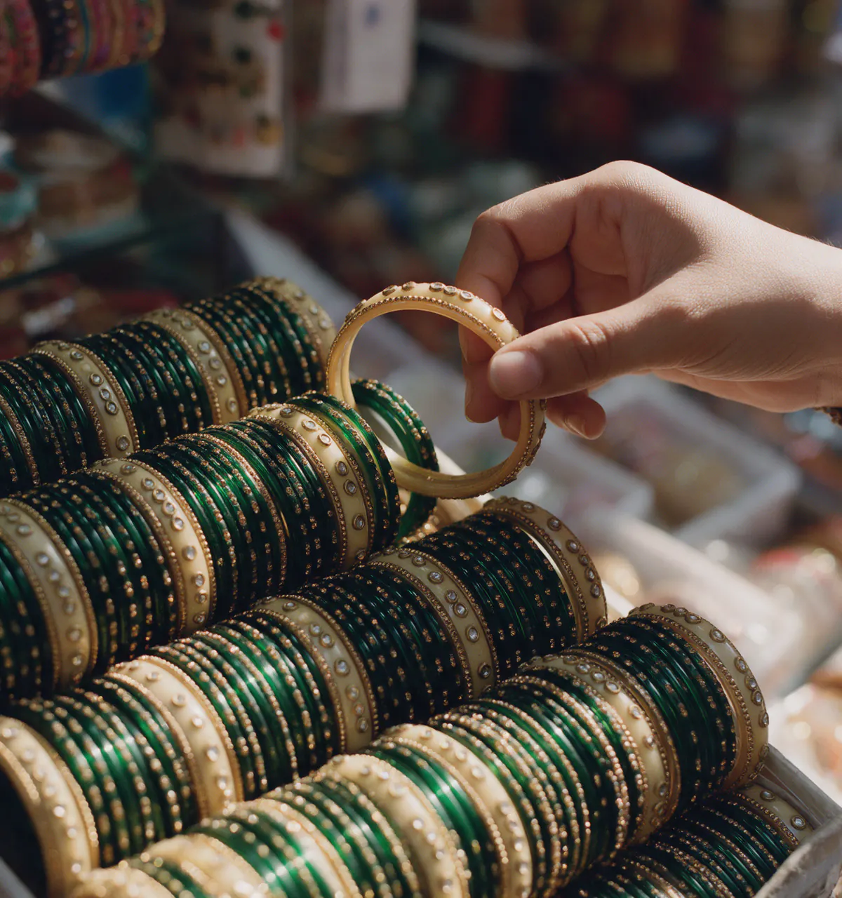Stacked green and gold lac bangles at a stall in Laad Bazaar, Hyderabad